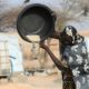 Every grain counts: A woman at a displaced persons' camp in Ouallam, Niger, pours food from a container