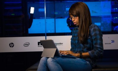 Woman in blue and black plaid using laptop computer