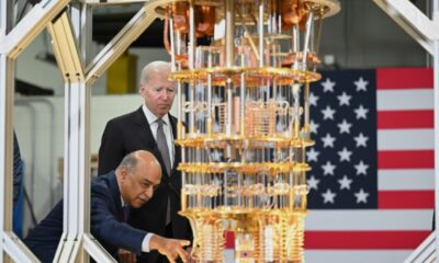 US President Joe Biden listens to IBM CEO Arvind Krishna as he tours the IBM facility in Poughkeepsie, New York