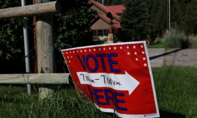 A sign directs voters to a polling place at the Old Wilson Schoolhouse August 16, 2022 in Wilson, Wyoming ahead of primary elections leading up to the Novermber 8 midterm elections