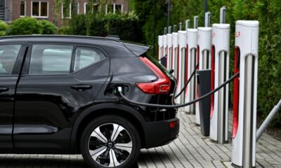 An electric car charges at a charging point reserved for Tesla cars