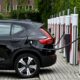 An electric car charges at a charging point reserved for Tesla cars