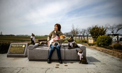 Atsuko Sato sits with her Japanese shiba inu dog Kabosu, best known as the face of the cryptocurrency Dogecoin