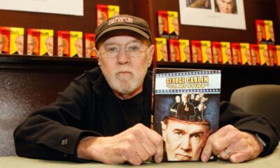 George Carlin poses with his book "All My Stuff" on December 11, 2007 in Los Angeles, California